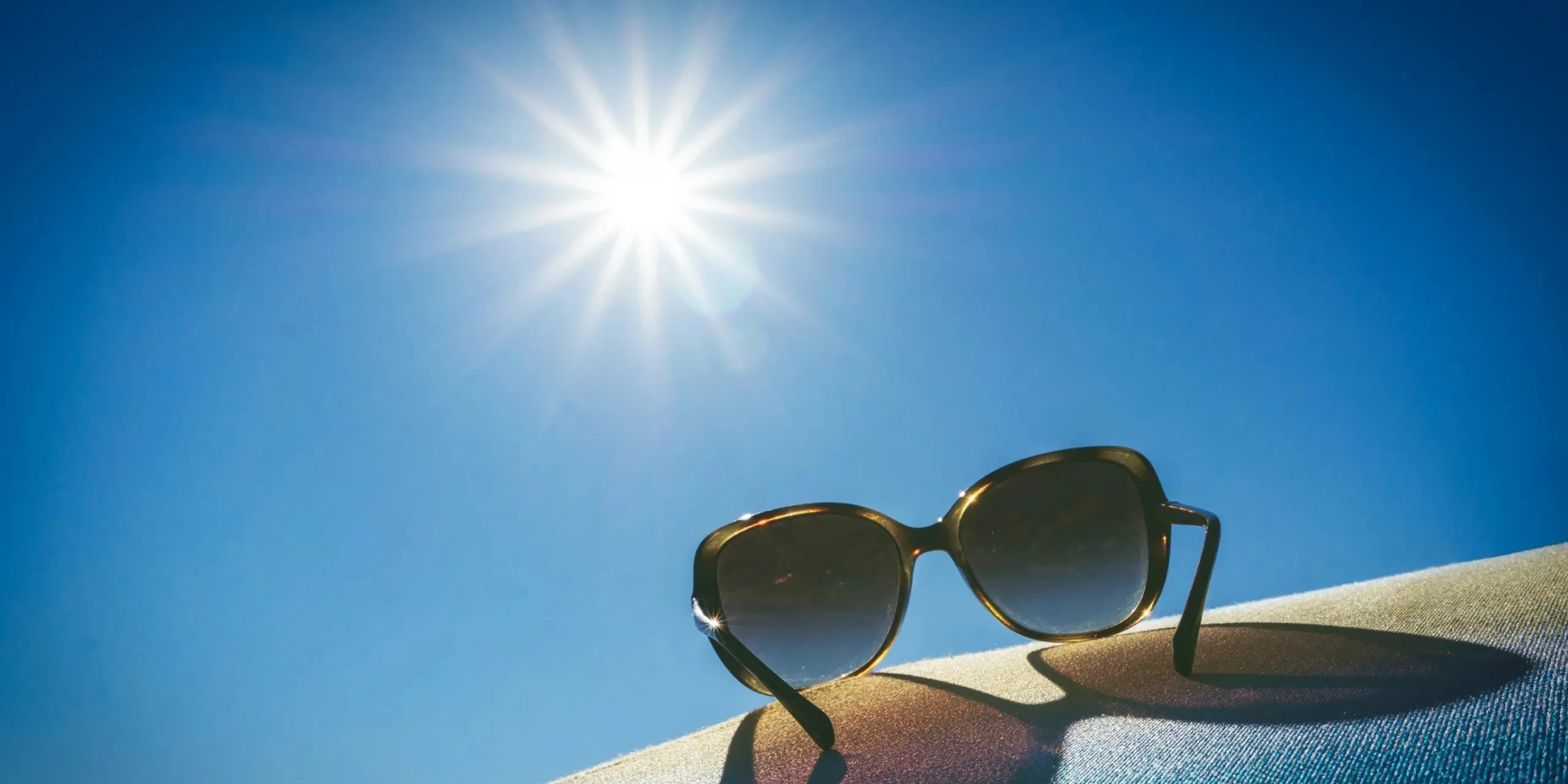 How to Prepare Your Garage Door for Summer in Utah (2026 Guide) Bright summer sun showing heat and UV exposure that affects garage doors