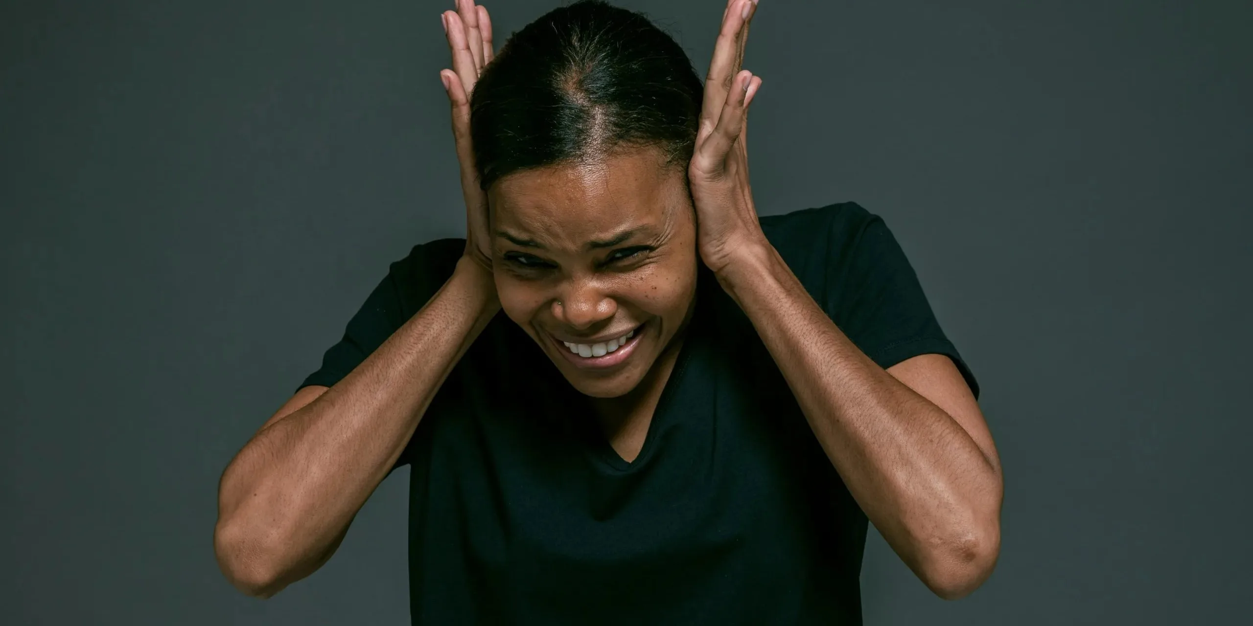 Why Is My Garage Door So Loud? Every Noise Explained (And How to Fix It) Person covering ears from loud garage door noise