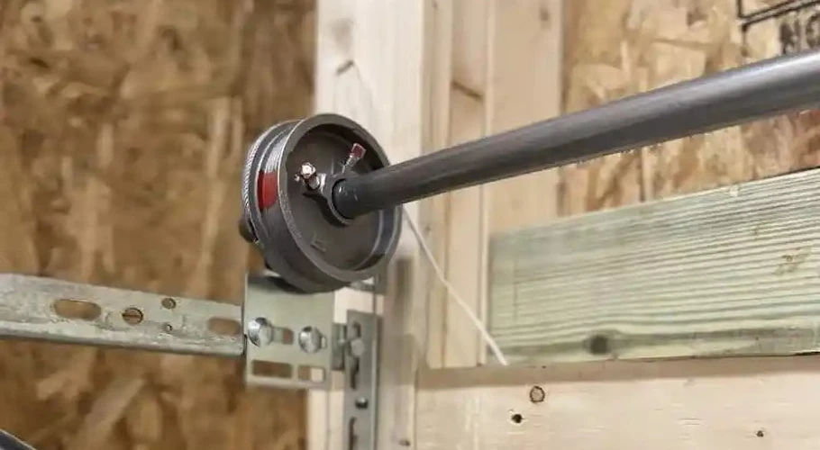 How a Garage Door Works: Every Part, System, and Mechanism Explained Close-up of a garage door cable drum and torsion spring mechanism