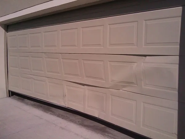 When to Replace Your Garage Door: A Complete Guide for Utah Homeowners Old weathered garage door showing signs it needs replacement