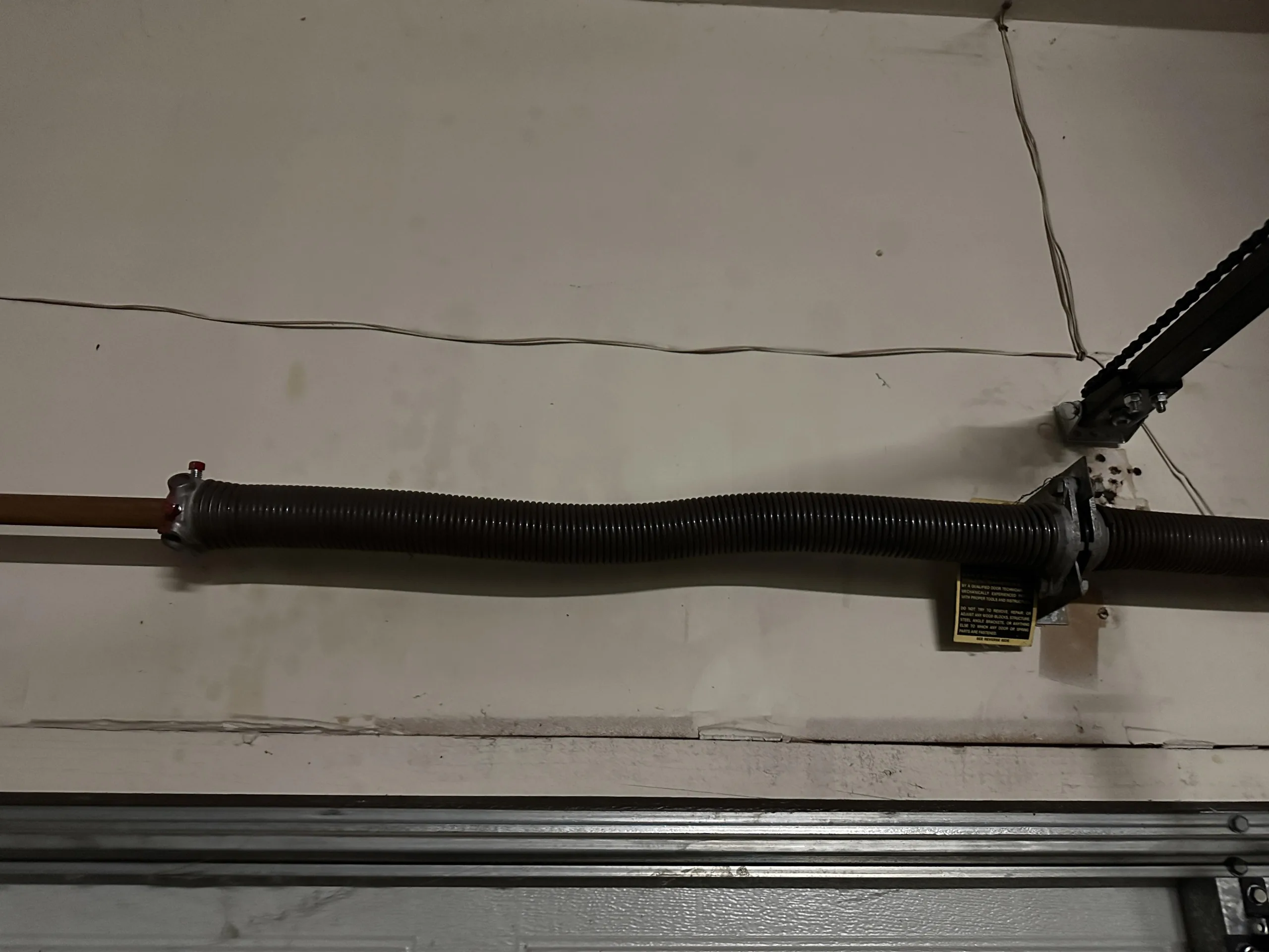 7 Warning Signs Your Garage Door Torsion Spring Is About to Break old_garage_door