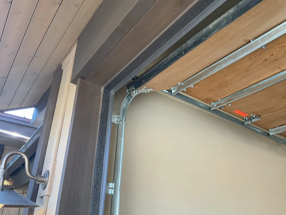 Garage Door Weatherstripping Replacement: The Complete Guide for Utah Homeowners Close-up of worn garage door weatherstripping being replaced on a Utah home