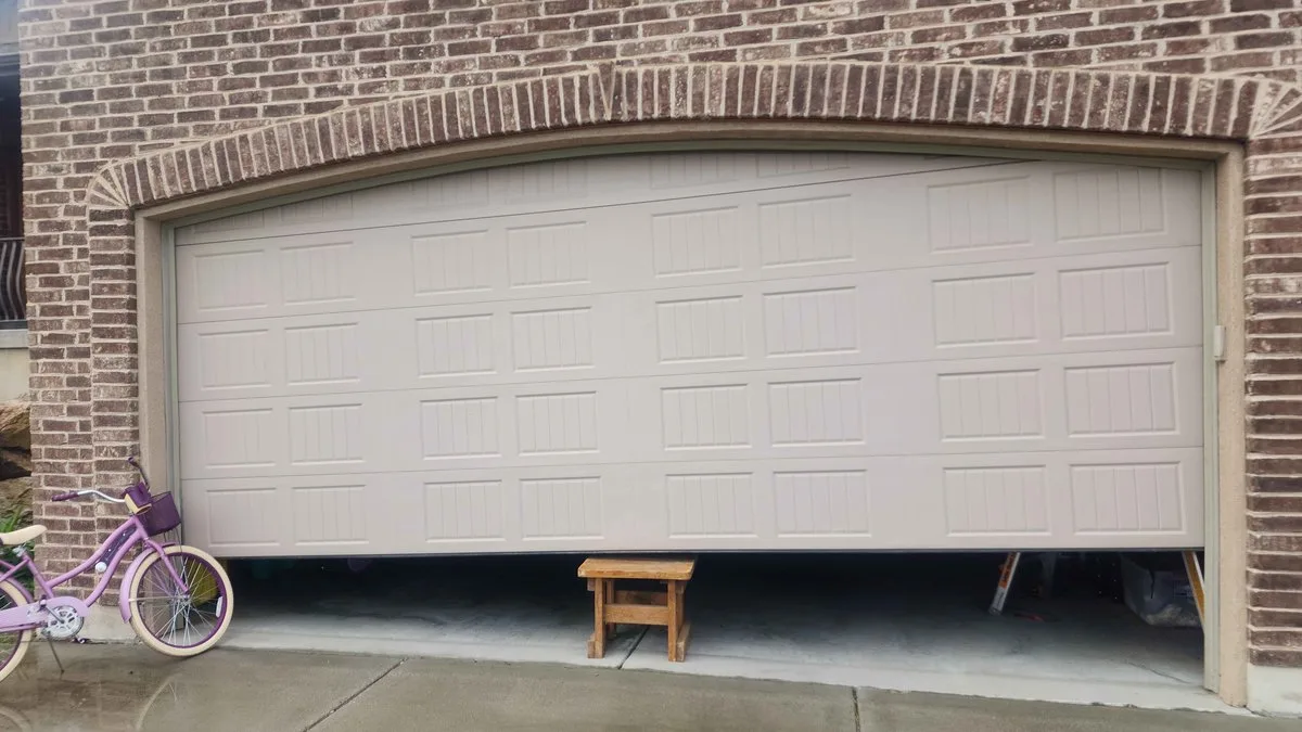 Why Is My Garage Door Crooked? Causes, Fixes, and When to Call a Pro Garage door hanging crooked with one side higher than the other