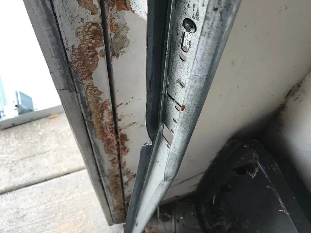 Garage Door Track Repair and Replacement: The Complete Guide for Utah Homeowners Garage door off track showing misaligned roller and bent track