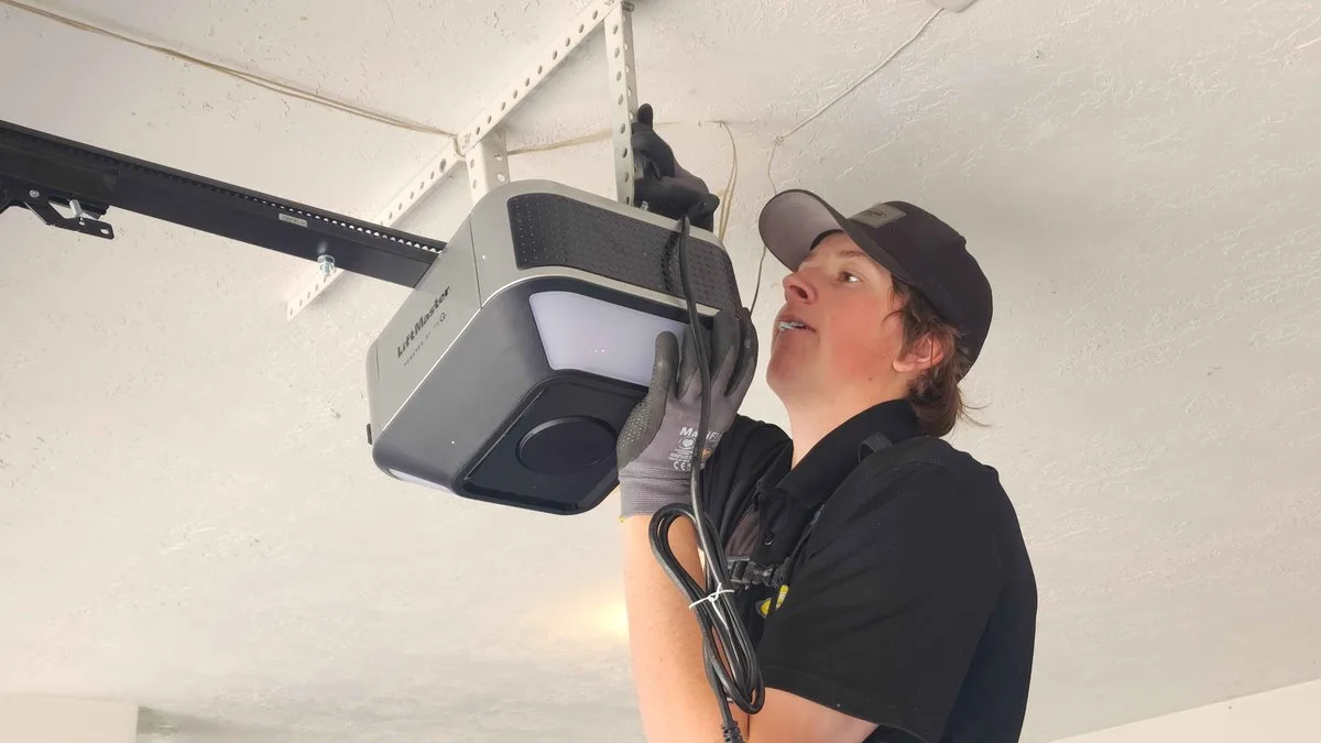 Garage Door Opener Installation: The Complete Guide for Utah Homeowners Professional technician installing a garage door opener on a residential garage ceiling