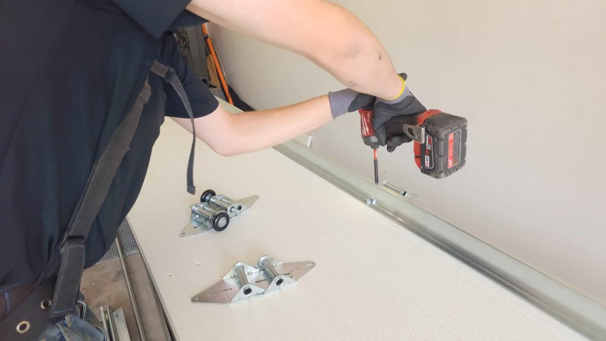Garage door strut reinforcement bars installed on interior panels