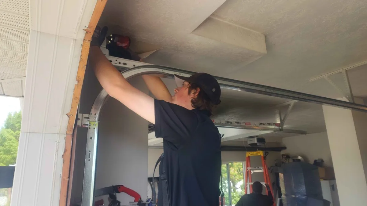 Garage Door Track Repair: The Complete Guide for Utah Homeowners Garage door track showing rollers and vertical-to-horizontal curve
