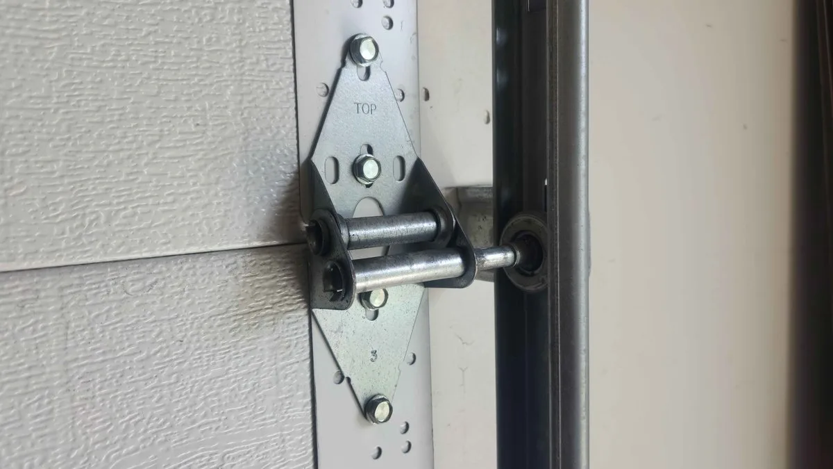 Why Is My Garage Door So Loud? Complete Noise Diagnosis Guide for Utah Homeowners Worn garage door rollers causing noise during operation