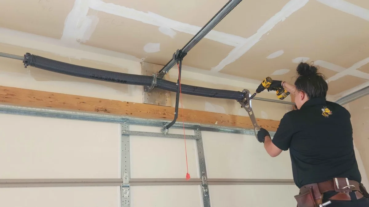 Torsion Spring Replacement: The Complete Guide for Utah Homeowners Professional technician replacing a torsion spring on a garage door